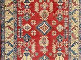 a red and blue rug with an ornate design