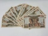 several bills of mexican currency are stacked on top of each other
