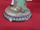 a figurine of a man riding a horse on a pedestal