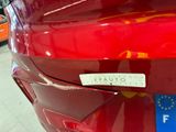 a close up of a red car with a sticker on it
