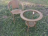 two chairs and a table in the grass