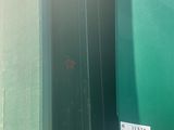 a green container with a sticker on the side of it