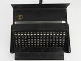 a close up of a black typewriter with numbers on it