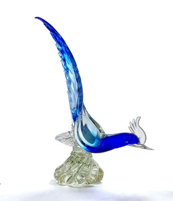 a glass bird that is flying in the air