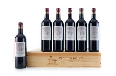 six bottles of red wine sit on a wooden crate next to a bottle of wine