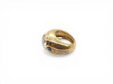 a close up of a gold ring with diamonds on a white background