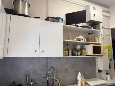 a kitchen with a sink, microwave, and cabinets in it