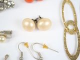 many different types of jewelry on a white surface