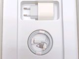 a white box with a charger and a cable in it