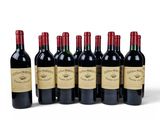six bottles of red wine lined up in a row on a white surface