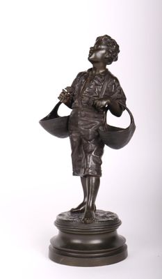 une vieille statue en bronze représentant une femme tenant un arrosoir