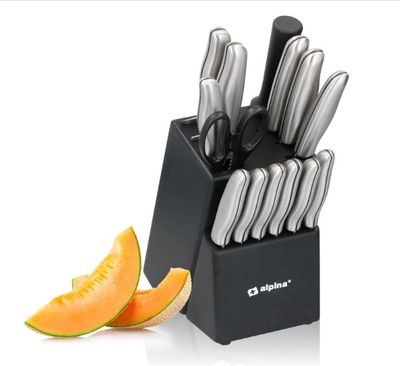 a picture of a knife set with a slice of melon next to it