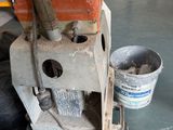 a machine that is sitting on the floor next to a bucket