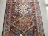 a large rug with a multicolored design on a white floor
