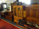 a lot of antique furniture on display in a store