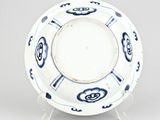 a blue and white plate with a design of flowers on it