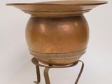 an image of a brass pot on a stand with a lid