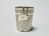 a silver cup with a number on it sitting on a table