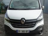 a white van parked in front of a building