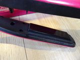 pink and black hair straightener sitting on top of a wooden table