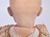 a close up of a doll ' s head and neck