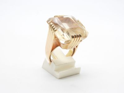 a close up of a gold ring with a stone in it