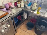 a kitchen with a sink, stove, dishwasher, and other items on the counter
