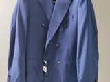 blue suit hanging on a hanger in a room