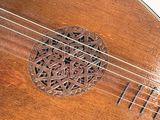 a close up view of a wooden instrument with a design on it