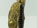 an image of a gold and black sword on a white surface