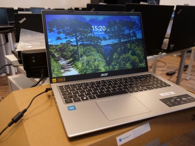a laptop computer sitting on top of a box on a table
