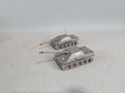 three toy tanks that are sitting on the ground