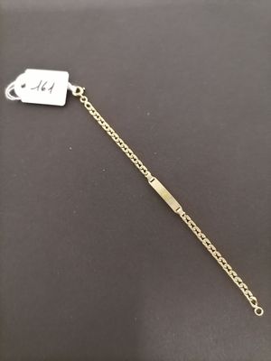 a gold chain bracelet with a tag on it