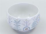 a white bowl with a blue flower design on it