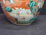 a large vase with a painting on it on a table