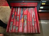 de nombreux outils dans une boîte à outils rouge posée par terre