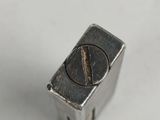 a small metal object that is on a white surface