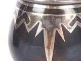 a black pot with a star design on it
