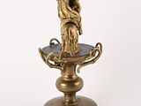 bronze figurine of a woman holding a child on a pedestal