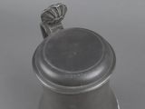 an antique pewware pot with a lid and a handle