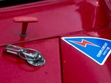 a close up of a red car with a blue triangle on it