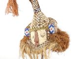 an image of a hat on a stand with feathers on it