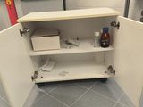 a white cabinet with a door open in a kitchen