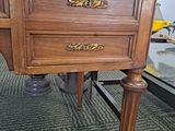 a wooden table with a glass top and a drawer on it