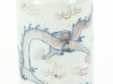 un vase blanc et bleu orné d'un motif représentant un dragon