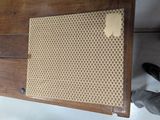 a wooden cabinet with a rattan top and a rattan top