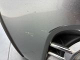 a close up of a car ' s front bumper with a denting on it