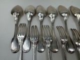 a lot of silver spoons and forks on the table