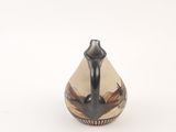 a black and white vase sitting on a white surface