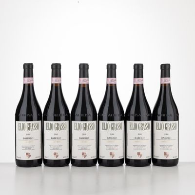 six bottles of red wine are lined up on a table